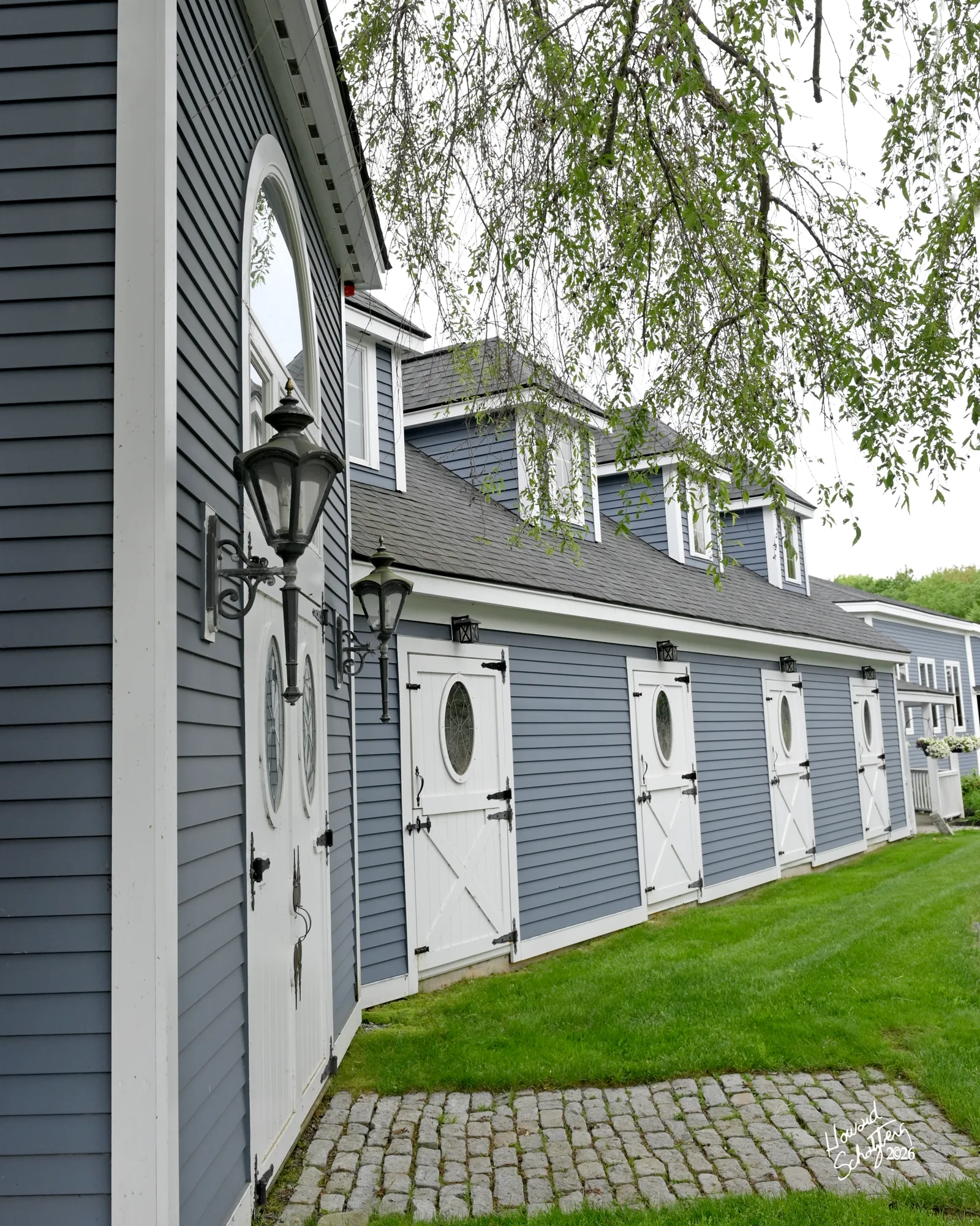 Blue-and-white training barn exterior at Rand Stables